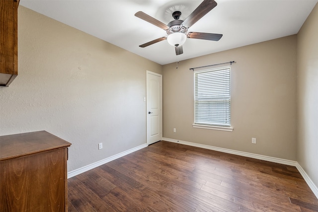 spare room featuring ceiling fan and dark hardwood / wood-style floors