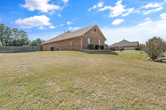 view of property exterior with a lawn, a garage, and central AC