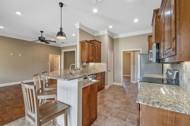 kitchen with a breakfast bar area, ornamental molding, kitchen peninsula, light stone countertops, and stainless steel range with electric stovetop