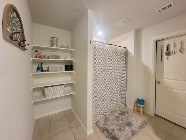 bathroom with tile patterned flooring and a shower with curtain