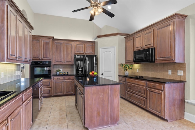 kitchen with light tile patterned flooring, a kitchen island, vaulted ceiling, black appliances, and dark stone countertops