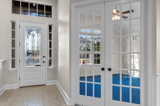 entrance foyer featuring light tile patterned floors and french doors