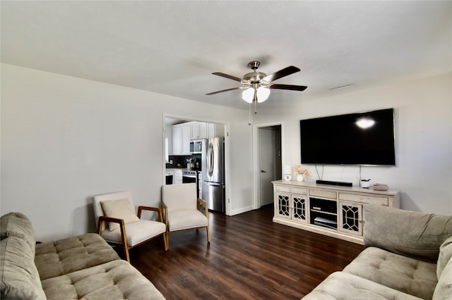 living room with ceiling fan and dark wood-type flooring