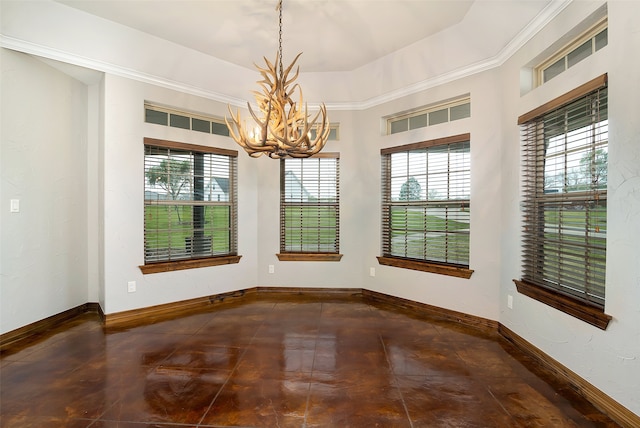 unfurnished dining area with a chandelier and a raised ceiling