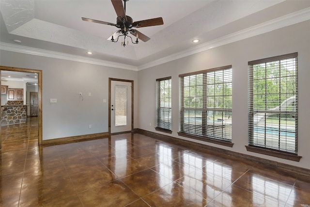 spare room with crown molding, ceiling fan, and a raised ceiling