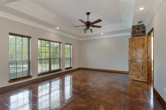 spare room featuring ornamental molding, a healthy amount of sunlight, ceiling fan, and a tray ceiling