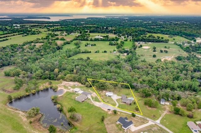 aerial view at dusk with a water view