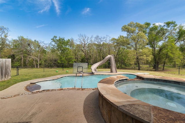 view of pool with an in ground hot tub and a water slide