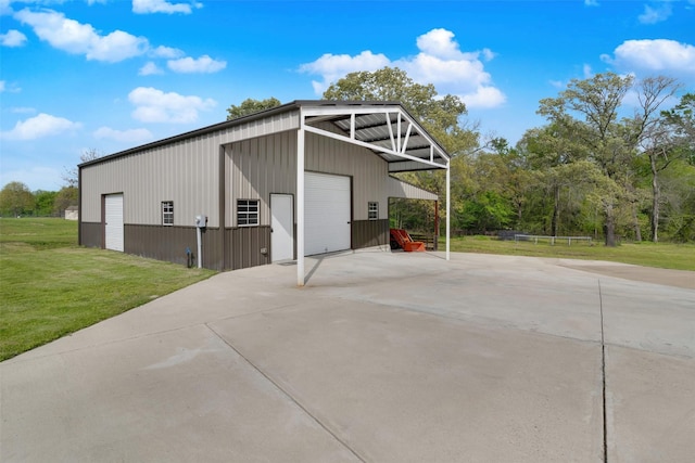 view of outdoor structure with a yard and a garage