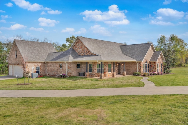 view of front facade with a garage, cooling unit, covered porch, and a front lawn