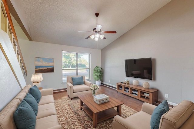 living room featuring high vaulted ceiling, ceiling fan, hardwood / wood-style floors, and a textured ceiling