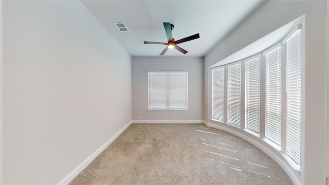 carpeted spare room with ceiling fan