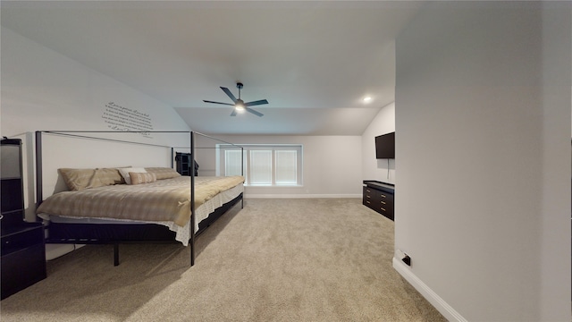 carpeted bedroom with ceiling fan and vaulted ceiling