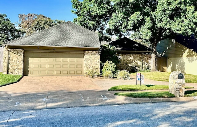 view of front of home with a garage and an outdoor structure