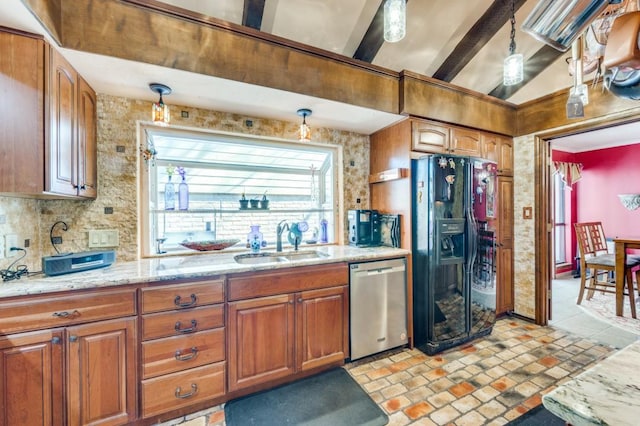 kitchen with pendant lighting, sink, backsplash, black refrigerator with ice dispenser, and stainless steel dishwasher