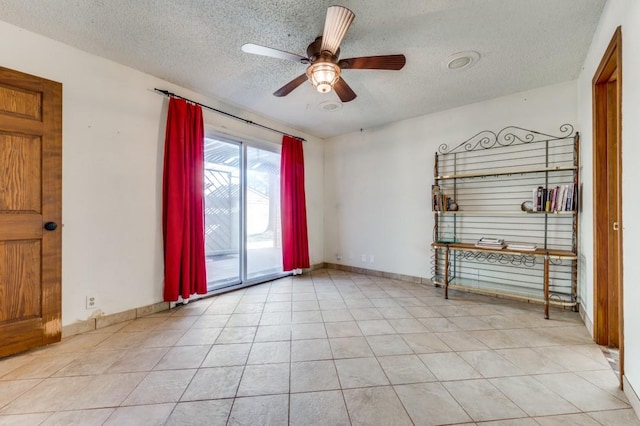 unfurnished room featuring ceiling fan, a textured ceiling, and light tile patterned flooring