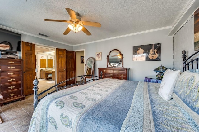 bedroom with tile patterned floors, ensuite bathroom, a textured ceiling, ornamental molding, and ceiling fan