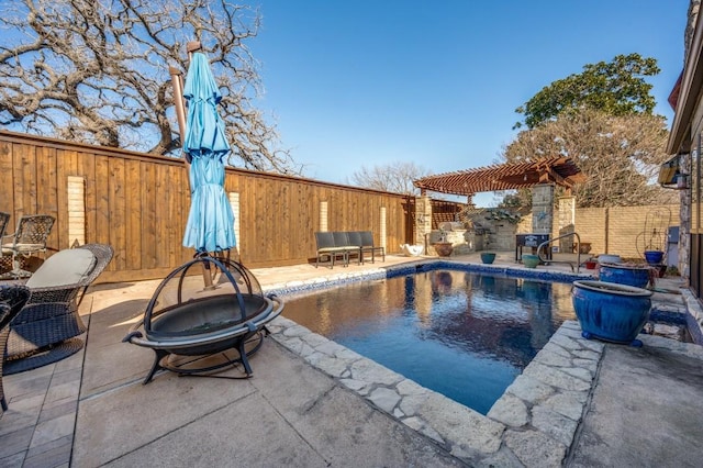 view of pool featuring a fire pit, a patio area, and a pergola