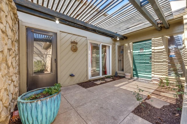 doorway to property with a pergola and a patio