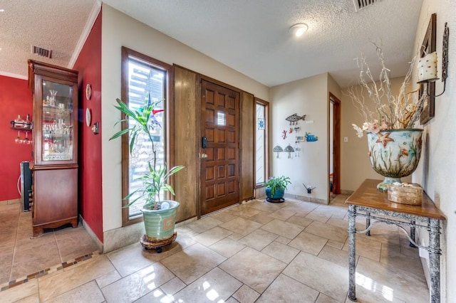 foyer entrance featuring a textured ceiling