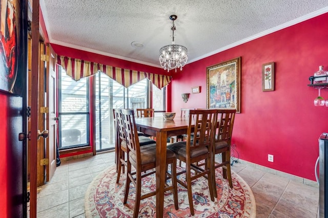 tiled dining area featuring crown molding, a textured ceiling, and an inviting chandelier