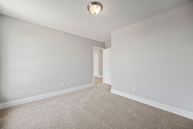 unfurnished room with light colored carpet