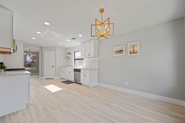 kitchen featuring white cabinets, dishwasher, light hardwood / wood-style floors, and hanging light fixtures