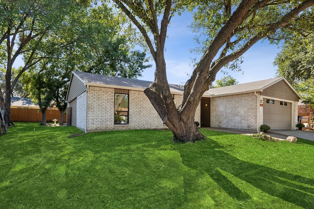 ranch-style house featuring a garage and a front yard