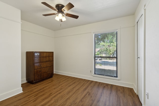 unfurnished bedroom with dark hardwood / wood-style flooring and ceiling fan