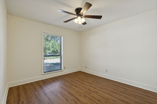 unfurnished room featuring ceiling fan and dark wood-type flooring