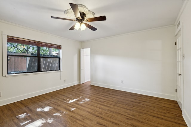 empty room with ceiling fan, dark hardwood / wood-style floors, and ornamental molding