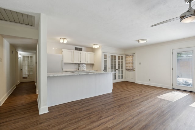 kitchen featuring sink, french doors, white cabinetry, white fridge, and dark hardwood / wood-style flooring