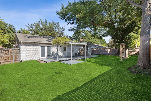 back of property featuring a lawn and a patio area