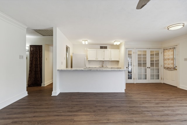 unfurnished living room with french doors, ornamental molding, and dark hardwood / wood-style flooring