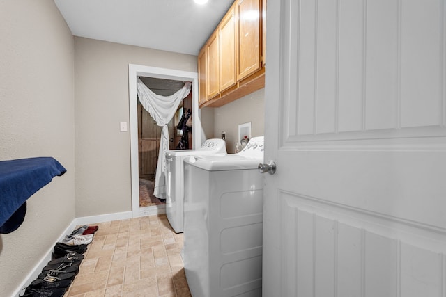 laundry area with cabinets and independent washer and dryer