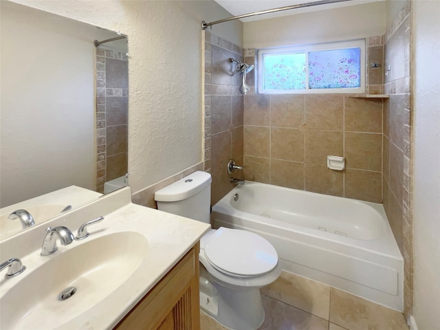 full bathroom featuring vanity, toilet, tile patterned floors, and tiled shower / bath