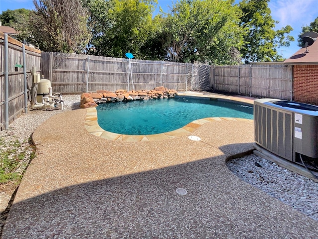 view of swimming pool with central AC unit