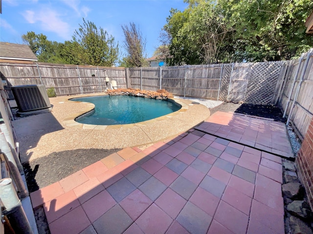 view of swimming pool with central AC unit and a patio area