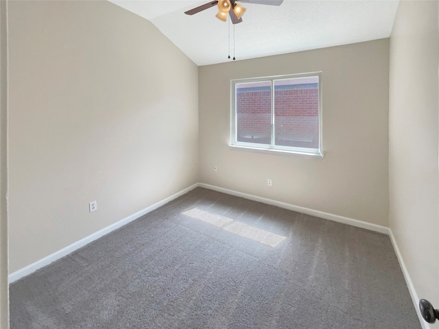 carpeted empty room featuring ceiling fan and vaulted ceiling