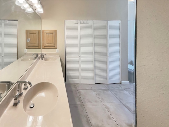 bathroom featuring tile patterned flooring, vanity, and toilet