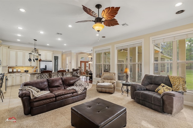 living room featuring ceiling fan, crown molding, and light tile patterned floors