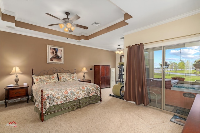 carpeted bedroom featuring access to outside, a tray ceiling, ornamental molding, and ceiling fan