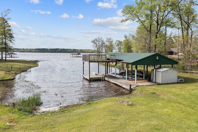 dock area featuring a lawn and a water view