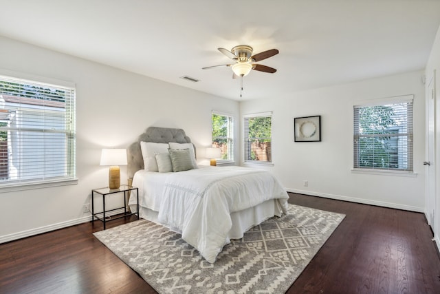 bedroom with ceiling fan and dark wood-type flooring