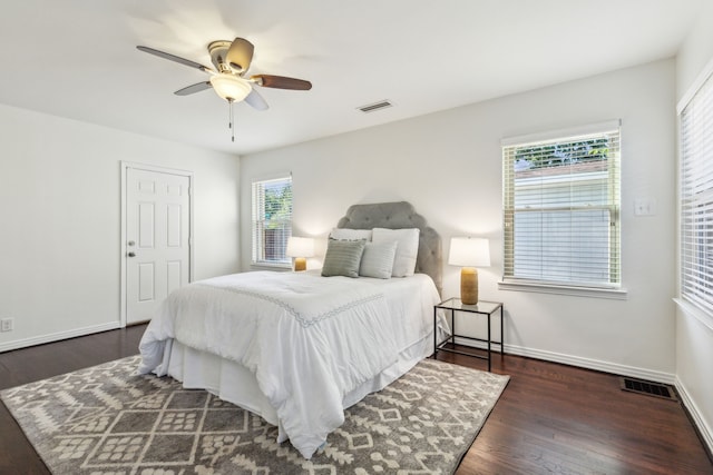 bedroom with ceiling fan and dark wood-type flooring