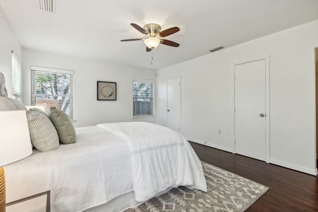 bedroom with ceiling fan and dark hardwood / wood-style flooring