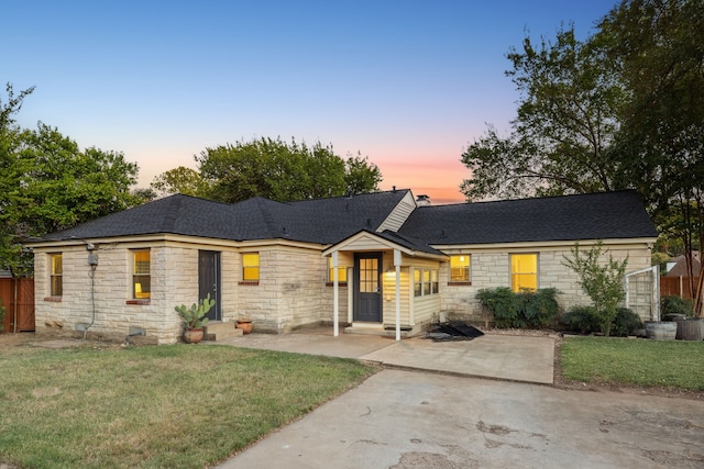 ranch-style house with a patio area and a yard