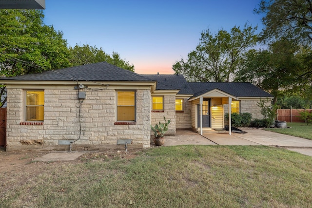 view of front of home featuring a patio area and a lawn