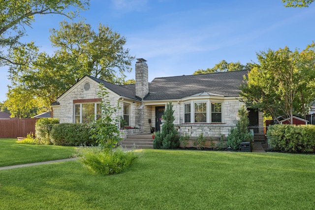 ranch-style home featuring a front lawn