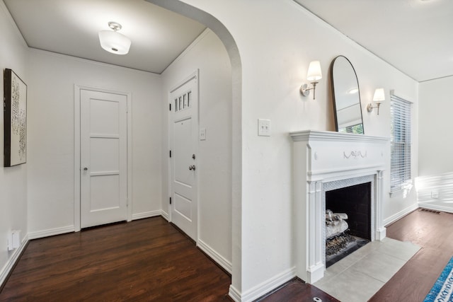 corridor featuring dark hardwood / wood-style flooring and ornamental molding